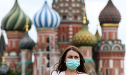 A woman wearing a protective face mask walks in front of the Saint Basil's Cathedral as part of the annual book fest on the Red Square in downtown Moscow on June 6, 2020, during the first public event since the country eased lockdown measures taken to curb the spread of the COVID-19 pandemic, caused by the novel coronavirus. (Photo by Kirill KUDRYAVTSEV / AFP)
