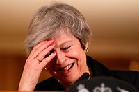 TOPSHOT - Britain's Prime Minister Theresa May reacts during a press conference inside 10 Downing Street in central London on November 15, 2018. - British Prime Minister Theresa May battled against a rebellion over her draft Brexit deal on Thursday, as ministers resigned and members of her own party plotted to oust her. (Photo by Matt Dunham / POOL / AFP)