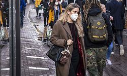 People wearing face masks walk on a shopping street in the center of Amsterdam on October 11, 2020. - The Dutch government is expected to take new measures to halt the spread the Covid-19 disease caused by the novel coronavirus. (Photo by Ramon van Flymen / ANP / AFP) / Netherlands OUT