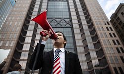 A protester yells into a megaphone at a rally at the Ohio State House in Columbus, Ohio on April 18, 2020, to protest the stay home order that is in effect until May 1st. (Photo by Megan JELINGER / AFP)