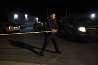 HALF MOON BAY, CALIFORNIA - JANUARY 23: A San Mateo County sheriff deputy pulls police tape across the entrance to a family reunification center following a mass shooting on January 23, 2023 in Half Moon Bay, California. Seven people were killed at two separate farm locations that were only a few miles apart in Half Moon Bay on Monday afternoon. The suspect, Chunli Zhao, was taken into custody a few hours later without incident.   Justin Sullivan/Getty Images/AFP (Photo by JUSTIN SULLIVAN / GETTY IMAGES NORTH AMERICA / Getty Images via AFP)
