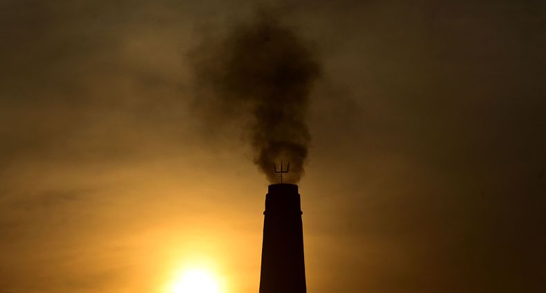 (FILES) In this file photo taken on March 15, 2023, smoke billows from a brick factory chimney on the outskirts of Prayagraj. - UN Secretary General Antonio Guterres called on wealthy countries on March 20, 2023, to move up their goals of achieving carbon neutrality as close as possible to 2040, mostly from 2050 now, in order to "defuse the climate time bomb." (Photo by SANJAY KANOJIA / AFP)