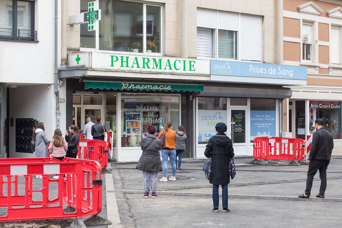 People have to keep a 2m distance as they wait outside pharmacies Photo: Lex Kleren