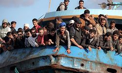 TOPSHOT - Rescued refugees and migrants stand aboard a boat at the town of Paleochora, southwestern Crete island on November 22, 2022, following a rescue operation. (Photo by Costas METAXAKIS / AFP)