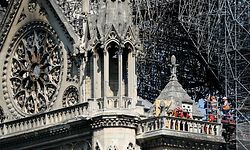Firefighters and technicians work on a balcony of Notre-Dame de Paris Cathedral in Paris on April 19, 2019, four days after a fire devastated the cathedral. - Thousands of Parisians and tourists watched in horror from nearby streets on April 15 as flames engulfed the building and rescuers tried to save as much as they could of the cathedral's treasures built up over centuries. (Photo by Lionel BONAVENTURE / AFP)