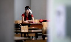 A student wearing a 3D printed face shield and gloves attends a class at the "Faik Konica" primary school in Pristina on June 9, 2020, as the schools in Kosovo gradually reopen, after almost three months of restrictions due to the risk of Covid-19 pandemic caused by the novel coronavirus. Armend NIMANI/AFP (Photo by Armend NIMANI / AFP)