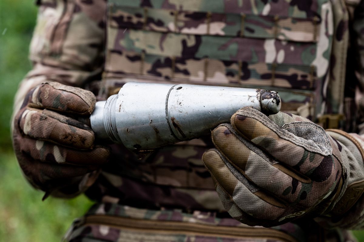 A detonator made of unexploded, suspected Russian ammunition collected and held by a member of a Ukrainian demining unit group