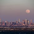 The full moon of April, called the Super Pink Moon, rises over the skyline of Manhattan on April 26, 2021. (Photo by Angela Weiss / AFP)