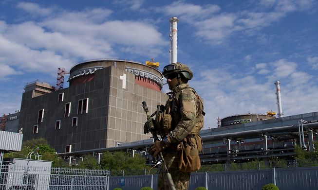 A Russian serviceman patrols the territory of the Zaporizhzhia Nuclear Power Station in Energoda