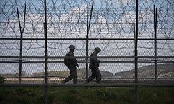 (FILES) This file photo taken on April 23, 2020 shows South Korean soldiers patrolling along a barbed wire fence Demilitarized Zone (DMZ) separating North and South Korea, on the South Korean island of Ganghwa. - North Korean troops fired multiple gunshots towards the South in the Demilitarized Zone dividing the peninsula on May 3, 2020, prompting South Korean forces to fire back, Seoul said. (Photo by Ed JONES / AFP)