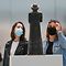 Visitors wearing face masks look at a piece displayed at the Louvre Lens museum reopened to the public on June 3, 2020 as France easing of lockdown measures taken to curb the spread of the COVID-19 pandemic, caused by the novel coronavirus. (Photo by DENIS CHARLET / AFP)