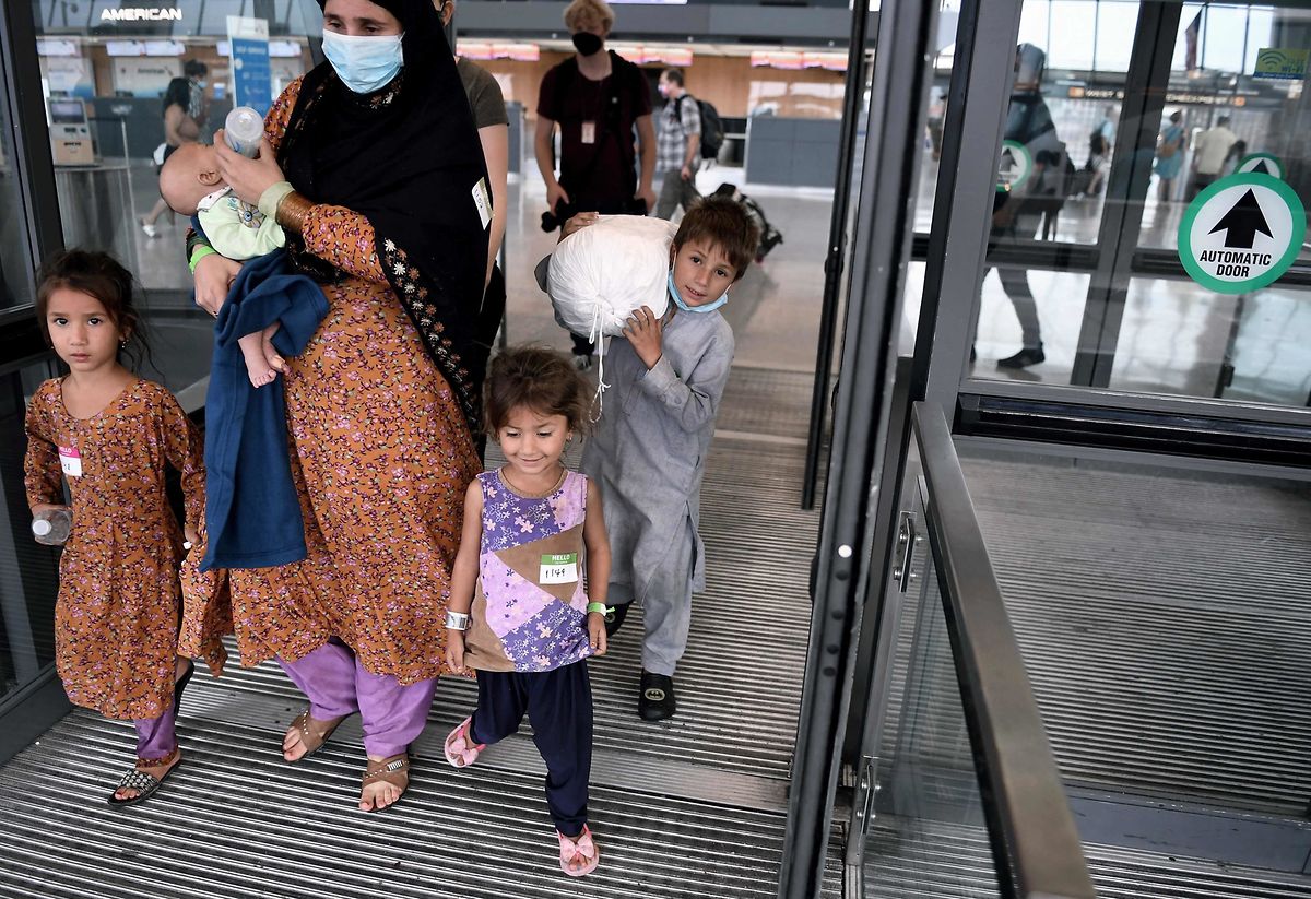Afghan refugees arrive at Dulles International Airport in Washington, DC, on Friday after being evacuated from Kabul. 