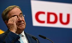 Germany's conservative Christian Democratic Union CDU leader and candidate for chancellor Armin Laschet adjusts his glasses as he gives a press statement in Berlin on October 7, 2021. - The beleaguered chief of Angela Merkel's CDU party signalled on October 7 that he was ready to step aside as leader of the conservatives, after an election debacle that has left them on the brink of the opposition. (Photo by Tobias Schwarz / AFP)
