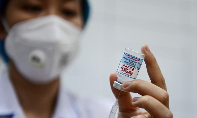 A health worker prepares to administer the Moderna Covid-19 coronavirus vaccine in Hanoi, Vietnam