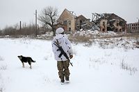 CORRECTION / TOPSHOT - A Ukrainian Military Forces serviceman walks in the village of Pesli, in the eastern Ukraine self-proclaimed Donetsk People's Republic (DPR), close to the front-line with Russia-backed separatists on January 25,2022. (Photo by Anatolii STEPANOV / AFP) / �The erroneous caption of this photo by Anatolii STEPANOV has been modified in AFP systems in the following manner: [A Ukrainian Military Forces serviceman walks in the village of Pesli, in the eastern Ukraine self-proclaimed Donetsk People's Republic (DPR), close to the front-line with Russia-backed separatists on January 25,2022.] instead of [A serviceman of Ukrainian Military Forces walks close to the front-line with Russia-backed separatists, in the village of Peski, in the self-proclaimed Donetsk People's Republic (DPR) in eastern Ukraine on January 25, 2022.  ]. Please immediately remove the erroneous mention[s] from all your online services and delete it (them) from your servers. If you have been authorized by AFP to distribute it (them) to third parties, please ensure that the same actions are carried out by them. Failure to promptly comply with these instructions will entail liability on your part for any continued or post notification usage. Therefore we thank you very much for all your attention and prompt action. We are sorry for the inconvenience this notification may cause and remain at your disposal for any further information you may require.�