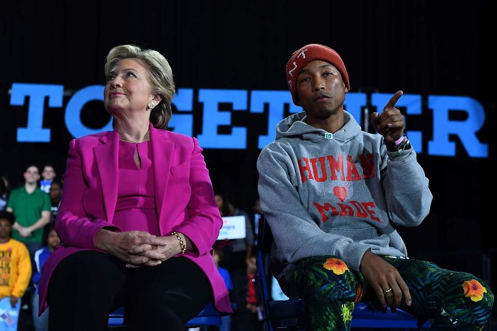 US Democratic presidential nominee Hillary Clinton and singer Pharrell Williams attend a campaign rally in Raleigh, North Carolina