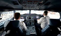 Picture taken on June 4, 2014 in Hamburg, northern Germany shows pilots in a cockpit of an airbus A380 operated by German airline Lufthansa. The Austrian aviation authority Austro Control imposed on March 27, 2015 the presence of two crew members in the cockpit throughout the flight, following the crash of the Germanwings Airbus on March 24, 2015, announced the Ministry of Transportation. AFP PHOTO / DPA / DANIEL REINHARDT GERMANY OUT