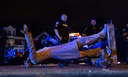 TOPSHOT - A statue of Confederate States President Jefferson Davis lies on the street after protesters pulled it down in Richmond, Virginia, on June 10, 2020. - The symbols of the Confederate States and its support for slavery are being targeted for removal following the May 25, 2020, death of George Floyd while in police custody. (Photo by Parker Michels-Boyce / AFP)