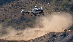 An helicopter of the Spanish Guardia Civil, transporting explosives, lands at the site where a child fell down a well in Totalan, southern Spain, on January 24, 2019. - A team of miners started digging a tunnel in a last-ditch bid to reach a two-year-old boy who fell into a well in Andalusia in southern Spain 11 days ago. The team of eight experts had waited days for a vertical shaft to be sunk into the hard, rocky soil, parallel to the well into which Julen Rosello tumbled on January 13. (Photo by JORGE GUERRERO / AFP)