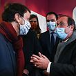 Lyon's Green Party Mayor Gregory Doucet (L) talks with former French President Francois Hollande (R) as they visit "Les petites cantines", a non-profit network of neighbourhood canteens, in Lyon, southeastern France, on March 2, 2021. (Photo by Philippe DESMAZES / AFP)