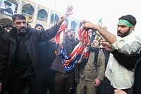 TOPSHOT - Iranians burn a US flag during a demonstration against American "crimes" in Tehran on January 3, 2020 following the killing of Iranian Revolutionary Guards Major General Qasem Soleimani in a US strike on his convoy at Baghdad international airport. - Iran warned of "severe revenge" and said arch-enemy the United States bore responsiblity for the consequences after killing one of its top commanders, Qasem Soleimani, in a strike  outside Baghdad airport. (Photo by ATTA KENARE / AFP)