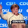 German Chancellor Angela Merkel waves after addressing the last rally of the conservative Christian Democratic Union CDU and its Bavarian sister-party Christian Social Union CSU in Munich on Friday