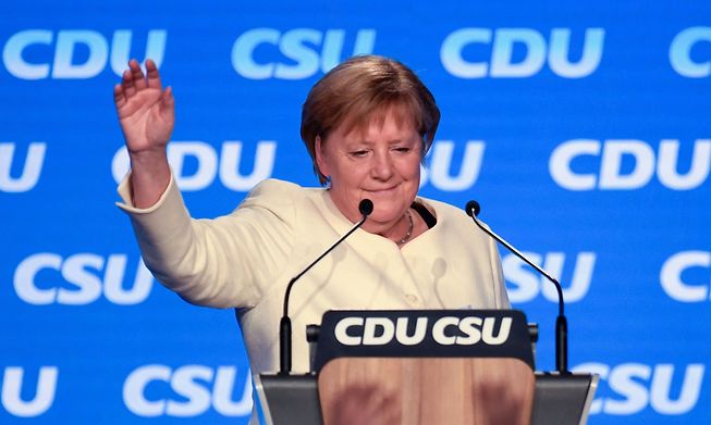 German Chancellor Angela Merkel waves after addressing the last rally of the conservative Christian Democratic Union CDU and its Bavarian sister-party Christian Social Union CSU in Munich on Friday