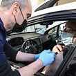 A nurse makes an injection of the Pfizer-BioNTech vaccine to a man in his car at a drive-in vaccination centre in Montpellier, on April 13, 2021, amid the sanitary crisis linked with the Covid-19 pandemic. (Photo by Pascal GUYOT / AFP)
