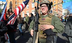 A pro gun supporter from Buffalo, New York carries a high caliber sniper rifle during a gun rights rally outside the Virginia State Capitol grounds in Richmond, Virginia on January 20, 2020. - Several thousand gun rights supporters massed near the Virginia state capitol Monday for a rally under heavy surveillance and a state of emergency declared by authorities fearing violence by far-right groups. Dressed in hunting jackets and caps, rally-goers were checked for weapons as they passed through tight security before entering a fenced off area of Richmond's Capitol Square for the so-called "Lobby Day" event. (Photo by Roberto SCHMIDT / AFP)
