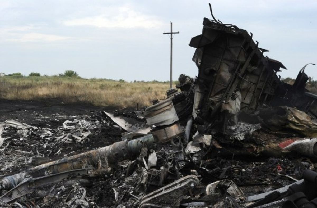 A picture taken on July 18, 2014 shows the wreckages of the Malaysia Airlines jet carrying 298 people from Amsterdam to Kuala Lumpur a day after it crashed, near the town of Shaktarsk, in rebel-held east Ukraine. Pro-Russian separatists in the region and officials in Kiev blamed each other for the crash, after the plane was apparently hit by a surface-to-air missile. All 298 people on board Flight MH17 died when the plane crashed. Rescue workers at the crash site said that they had found one of the black boxes from the passenger liner. AFP PHOTO/DOMINIQUE FAGET
