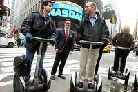 NEW YORK - NOVEMBER 18:  (FILE PHOTO) Amazon.com CEO Jeff Bezos (R) stands on a Segway with Segway inventor Dean Kamen (L) and NASDAQ Vice Chairman David Weild (C) after opening the NASDAQ Stock Market November 18, 2002 in New York City. The Consumer Product Safety Commission announced September 26, 2003 that Segway LLC has recalled all 6000 Segways sold since March 2002 because of dangers associated with low batteries that may cause the human transporter to fall.  (Photo by Mario Tama/Getty Images)
