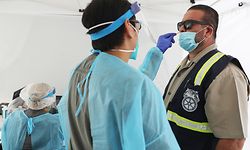 LONG BEACH, CALIFORNIA - JULY 16: Teamsters Local 848 business agent Reyes Magana is tested for COVID-19 at a testing site provided by the International Brotherhood of Teamsters on July 16, 2020 in Long Beach, California. The coronavirus nasal swab testing was conducted for port truck drivers and warehouse workers in conjunction with a St. Johns Well Child & Family Center mobile clinic. California reported over 11,000 new coronavirus infections July 15, the most in the state in a single day since the pandemic began.   Mario Tama/Getty Images/AFP
== FOR NEWSPAPERS, INTERNET, TELCOS & TELEVISION USE ONLY ==