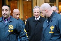 Disgraced financier Bernard Madoff, center, leaves U.S. District Court in Manhattan escorted by U.S. Marshals after a bail hearing in New York, Monday, Jan. 5, 2009.  Prosecutors on Monday said Madoff violated bail conditions by mailing about $1 million worth of jewelry and other assets to relatives and should be jailed without bail.  (AP Photo/Kathy Willens)