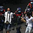 TOPSHOT - Police arrest people in Yangon on February 27, 2021, as protesters were taking part in a demonstration against the military coup. (Photo by Sai Aung Main / AFP)