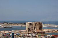 A picture shows the damaged grain silos at the port of the Lebanese capital Beirut, on August 2, 2022, following a partial collapse due to an ongoing fire since the beginning of the month. - On August 4, Lebanon will mark two years since the port's massive explosion that killed more than 200 people. It was caused by a stockpile of haphazardly stored ammonium nitrate fertiliser catching fire. The silos, had shielded the western part of the Lebanese capital when the  catastrophic blast took place two years ago. (Photo by PATRICK BAZ / AFP)
