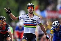 Slovakia's Peter Sagan celebrates as he crosses the finish line ahead of Belgium's Greg Van Avermaet (L) and Ireland's Daniel Martin at the end of the 212,5 km third stage of the 104th edition of the Tour de France cycling race on July 3, 2017 between Verviers, Belgium and Longwy, France. / AFP PHOTO / Jeff PACHOUD
