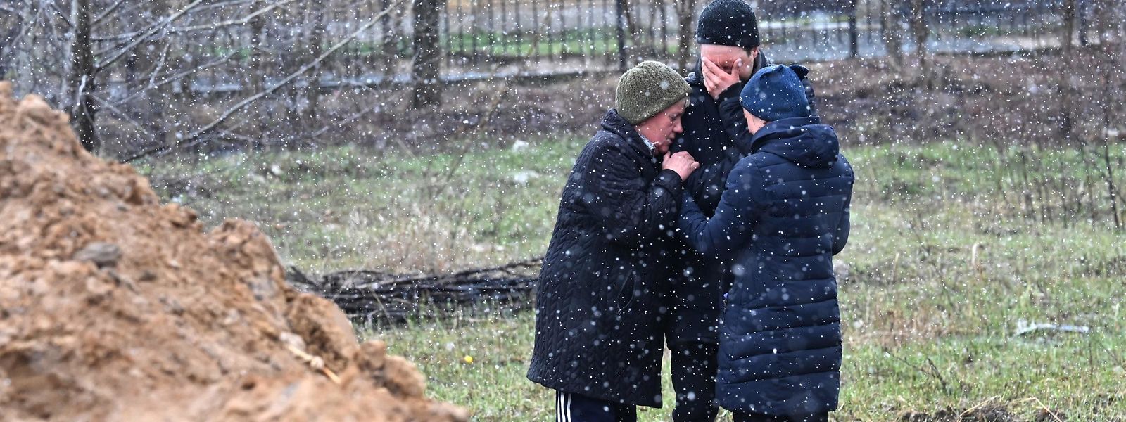 Trauernde in der Nähe eines Massengrabs in der ukrainischen Kleinstadt Butscha. 