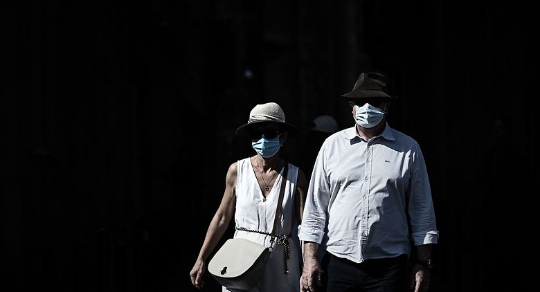 Pedestrians wearing protective face masks due to the COVID-19 disease caused by the novel coronavirus, walk in a street of Bordeaux, southwestern France, on September 14, 2020. (Photo by Philippe LOPEZ / AFP)