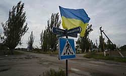 TOPSHOT - A photograph taken on September 27, 2022, shows Ukrainian flag waves on a street of the recently liberated village of Vysokopillya, Kherson region,amid the Russian invasion of Ukraine. (Photo by Genya SAVILOV / AFP)