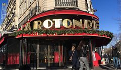 People walk past the Rotonde restaurant in Paris' Montparnasse district on January 18, 2020 after a fire broke out overnight. - The Rotonde restaurant is one of the iconic locations in the Montparnasse district where French President Emmanuel Macron hosted a party after his first round victory in the May 2017 presidential election. (Photo by Aurore MESENGE / AFP)
