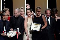 French director Julia Ducournau (C) poses on stage with guests and laureates after she won the Palme d'Or for her film "Titane" during the closing ceremony of the 74th edition of the Cannes Film Festival in Cannes, southern France, on July 17, 2021. (Photo by CHRISTOPHE SIMON / AFP)