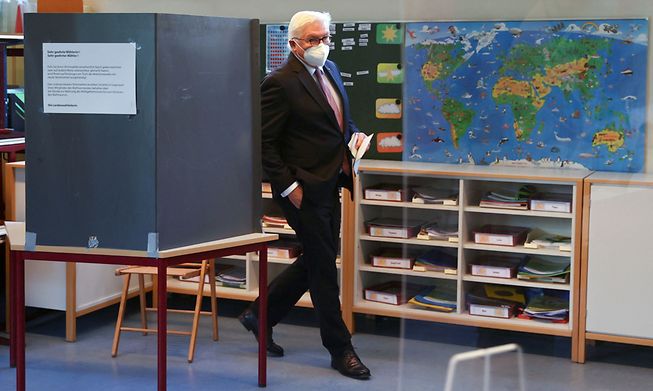 German President Frank-Walter Steinmeier leaves a voting booth after casting his ballot at a polling station in Berlin on Sunday