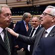 TOPSHOT - UK Independence Party (UKIP) leader Nigel Farage (L) talks with EU Commission President Jean-Claude Juncker before a plenary session at the EU headquarters in Brussels on June 28, 2016. 
European Commission chief Jean-Claude Juncker called on June 28 on Prime Minister David Cameron to clarify quickly when Britain intends to leave the EU, saying there can be no negotiation on future ties before London formally applies to exit. / AFP PHOTO / JOHN THYS