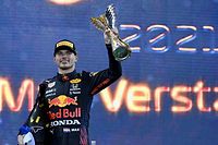 2021 FIA Formula One World Champion Red Bull's Dutch driver Max Verstappen celebrates on the podium of the Yas Marina Circuit after the Abu Dhabi Formula One Grand Prix on December 12, 2021. - Max Verstappen became the first Dutchman ever to win the Formula One world championship title when he won a dramatic season-ending Abu Dhabi Grand Prix at the Yas Marina circuit on December 12, 2021. The Red Bull driver won his 10th race of the season to finish ahead of seven-time champion Lewis Hamilton. (Photo by ANDREJ ISAKOVIC / POOL / AFP)