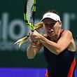 Denmark's Caroline Wozniacki hits a return against Ukraine's Elina Svitolina during their singles match at the WTA Finals tennis tournament in Singapore on October 25, 2018. (Photo by Roslan RAHMAN / AFP)