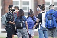 TAMPA, FL - AUGUST 31: Students at Hillsborough High School wait in line to have temperature checked before entering the building on August 31, 2020 in Tampa, Florida. The Hillsborough County Schools District gives their students the in-class learning option amid the coronavirus pandemic.   Octavio Jones/Getty Images/AFP
== FOR NEWSPAPERS, INTERNET, TELCOS & TELEVISION USE ONLY ==
