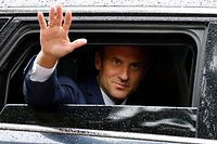 France's President Emmanuel Macron waves as he leaves after casting his vote in the second stage of French parliamentary elections at a polling station in Le Touquet, northern France on June 19, 2022. (Photo by Ludovic MARIN / AFP)