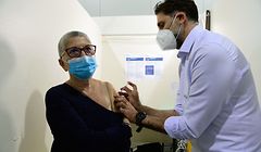 A nurse administers a dose of the  Pfizer/BioNTech Covid-19 vaccine to a member of the public at a vaccination centre set up in the Parc Chanot exhibition centre in Marseille, southeastern France, on April 19, 2021, as part of France's vaccination campaign aimed at stemming the spread of the Covid-19 pandemic. (Photo by Nicolas TUCAT / AFP)