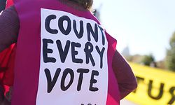 A demonstrator protests with a sign on their back near the White House on November 4, 2020 in Washington, DC. - US President Donald Trump alleged on Wednesday that there had been "surprise ballot dumps" in states where he had been leading Democrat Joe Biden in the race for the White House. "Last night I was leading, often solidly, in many key States, in almost all instances Democrat run & controlled," Trump tweeted. "Then, one by one, they started to magically disappear as surprise ballot dumps were counted." (Photo by Alex Edelman / AFP)