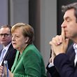 German Chancellor Angela Merkel (C), Bavaria's State Premier Markus Soeder (R) and Berlin's Mayor Michael Mueller (L) participate in a press conference following talks via video conference with Germany's state premiers on the extension of the current lockdown, at the Chancellery in Berlin on March 23, 2021. - Germany will enter a strict shutdown for five days over Easter in a bid to halt soaring coronavirus infection rates, Chancellor Angela Merkel said March 23, 2021, after marathon talks with regional leaders.  As well as extending existing measures including keeping cultural, leisure and sporting facilities shut through to April 18, Merkel and Germany's 16 state premiers agreed a tougher shutdown between April 1 and 5. (Photo by Michael Kappeler / POOL / AFP)